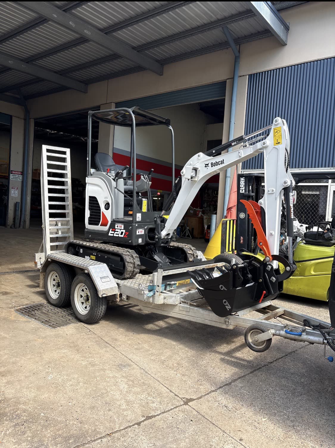 Bobcat E20z mini excavator loaded on the plant trailer